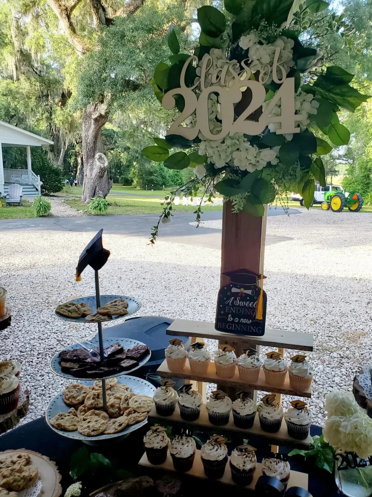 A dessert display topped with a Class of 2024 sign for a graduation party