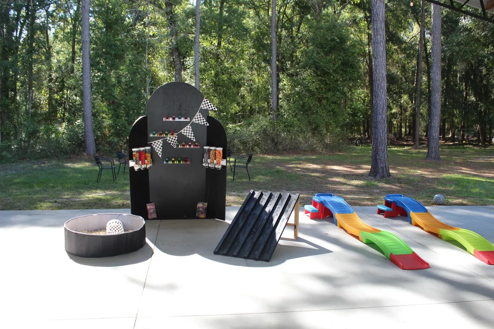 Lawn games set out on the concrete pad beside the pavilion for a party