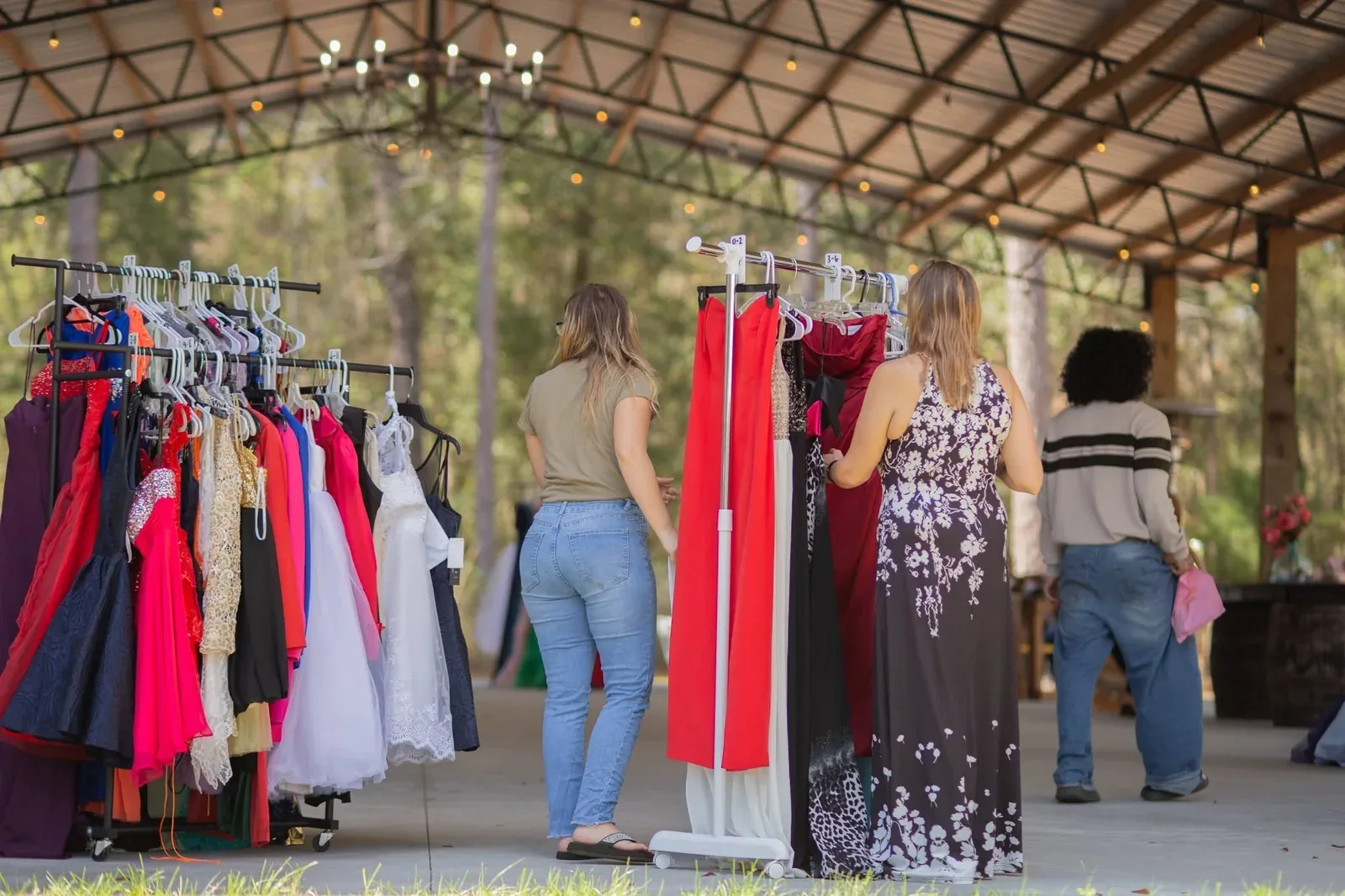Teenagers browsing the racks of donated formalwear at the prom dress drive